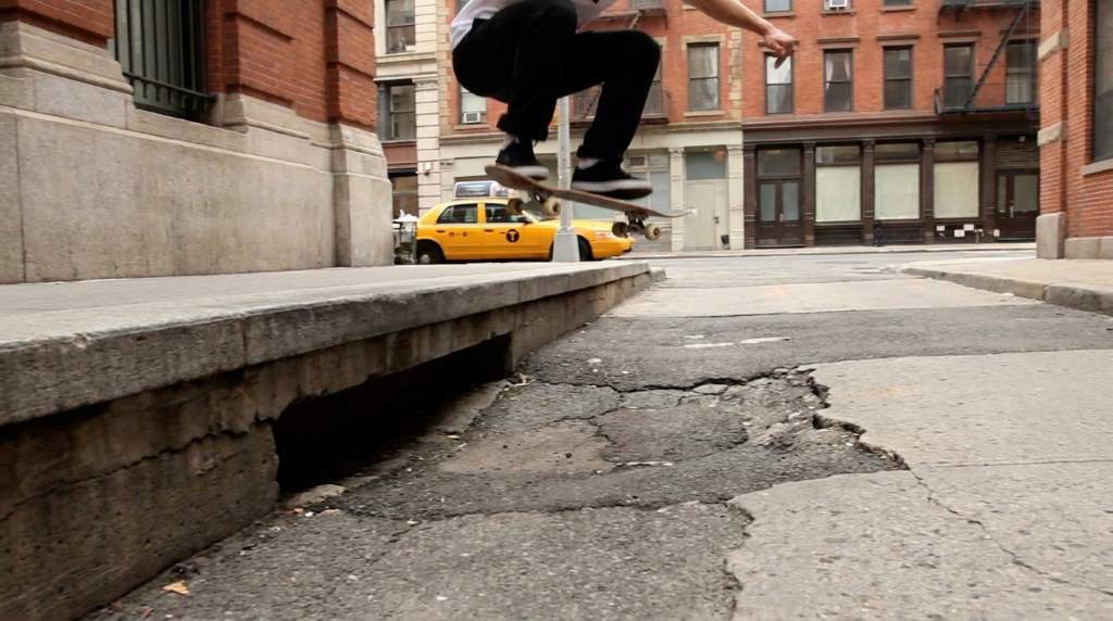 Skateboarder checking pavement before attempting a street gap